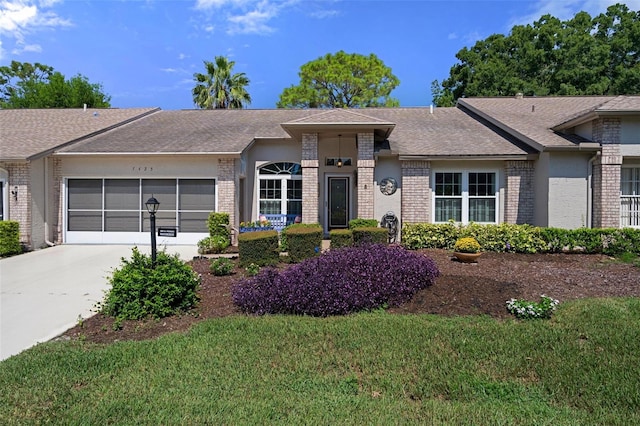 single story home with a garage and a front yard