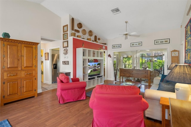 living room with ceiling fan, high vaulted ceiling, and hardwood / wood-style flooring