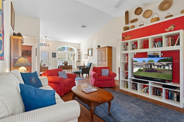 living room featuring hardwood / wood-style floors, ceiling fan, and lofted ceiling