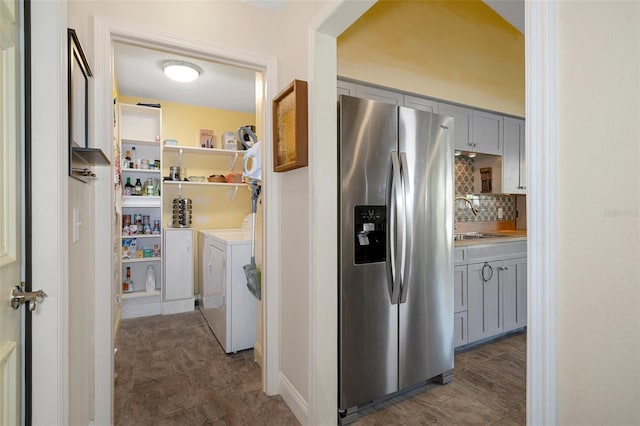 clothes washing area featuring sink, washer and dryer, and a textured ceiling