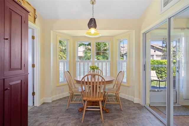 dining space with tile patterned floors and a healthy amount of sunlight