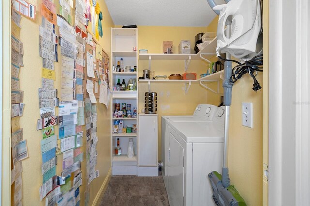 clothes washing area featuring tile patterned floors, water heater, a textured ceiling, and independent washer and dryer