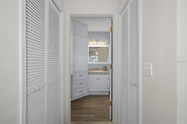 hallway with sink and dark wood-type flooring