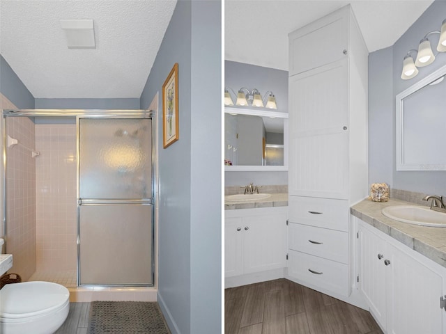 bathroom featuring walk in shower, hardwood / wood-style floors, a textured ceiling, toilet, and vanity