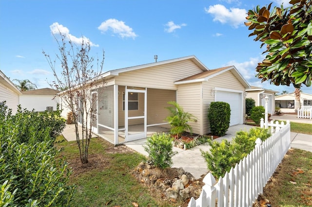 view of front of property featuring a sunroom and a garage