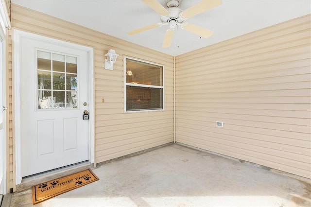 entrance to property featuring ceiling fan