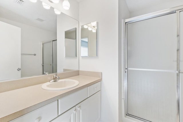 bathroom with vanity and walk in shower