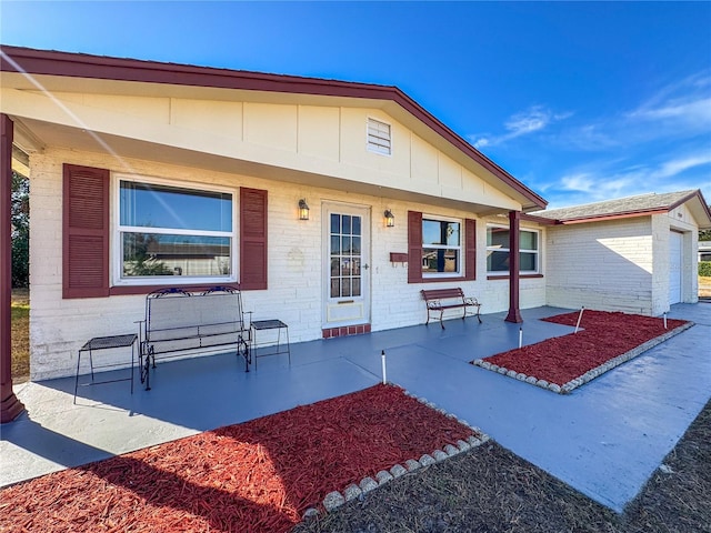 view of front facade with a patio area and a garage