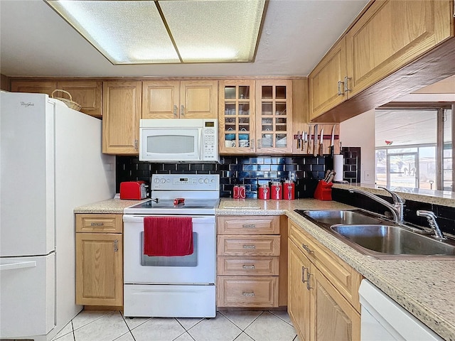 kitchen with light brown cabinetry, tasteful backsplash, white appliances, sink, and light tile patterned floors