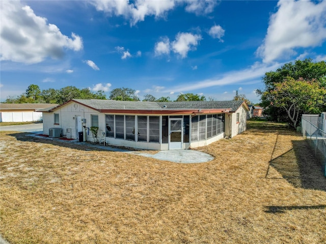 rear view of property with a sunroom and central AC