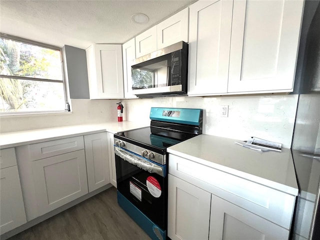 kitchen featuring a textured ceiling, black range with electric stovetop, white cabinets, and dark hardwood / wood-style floors