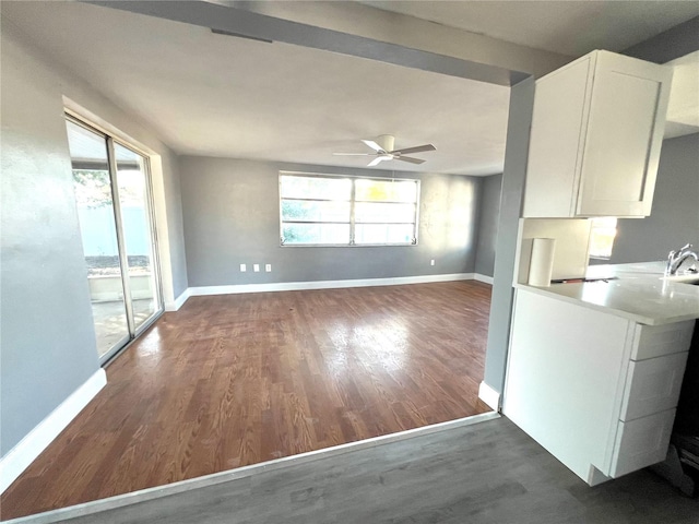 kitchen featuring white cabinetry, plenty of natural light, ceiling fan, and dark wood-type flooring