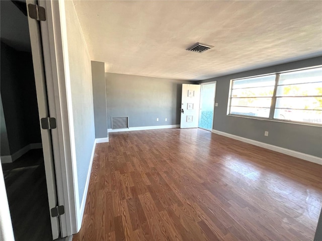 empty room featuring wood-type flooring