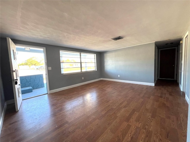 spare room featuring dark hardwood / wood-style flooring