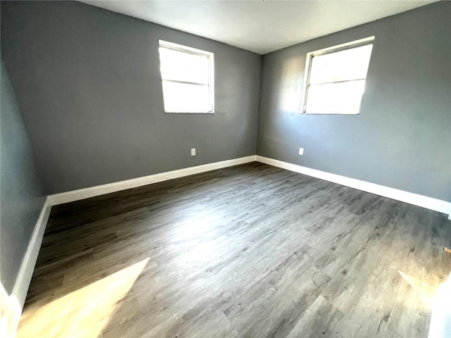 spare room with a healthy amount of sunlight and wood-type flooring