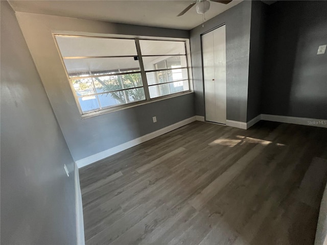 spare room featuring ceiling fan, plenty of natural light, and dark hardwood / wood-style floors