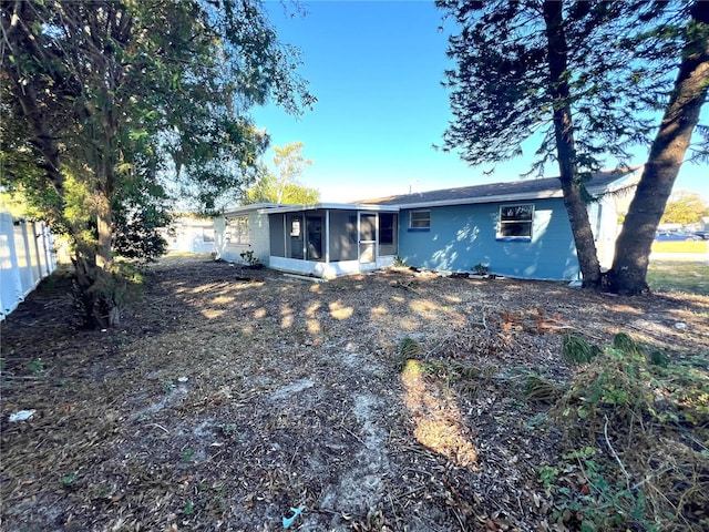 rear view of property with a sunroom