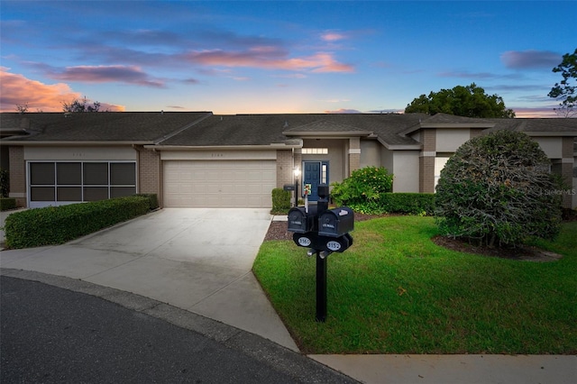 view of front of house with a yard and a garage