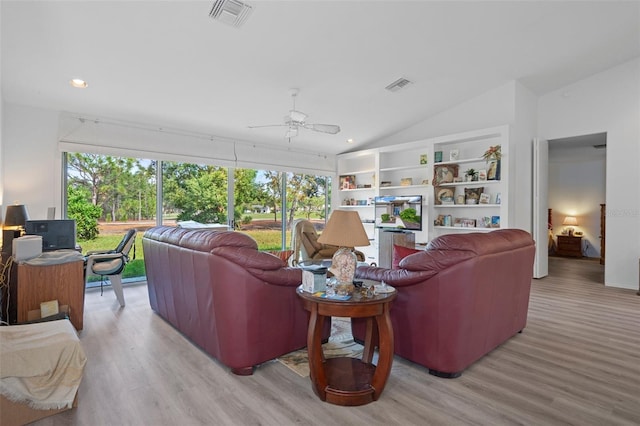 living room featuring light wood-type flooring, vaulted ceiling, and ceiling fan