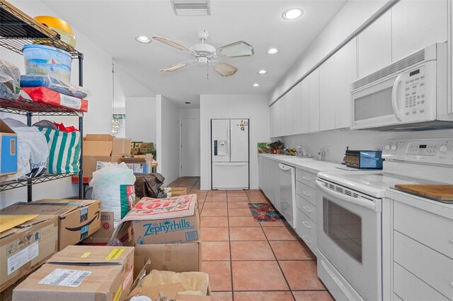 kitchen with white appliances, white cabinets, sink, ceiling fan, and light tile patterned floors