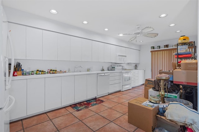 kitchen featuring white appliances, white cabinetry, sink, ceiling fan, and light tile patterned floors