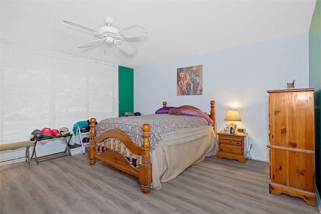 bedroom with ceiling fan and hardwood / wood-style flooring