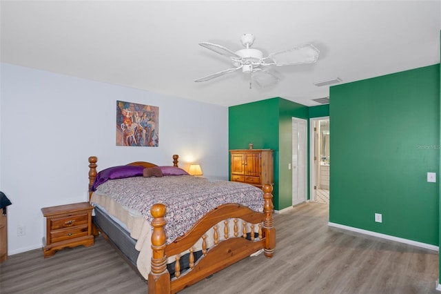 bedroom featuring a closet, ceiling fan, connected bathroom, and hardwood / wood-style flooring