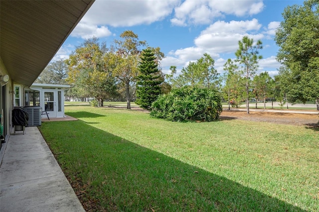 view of yard with a sunroom and cooling unit