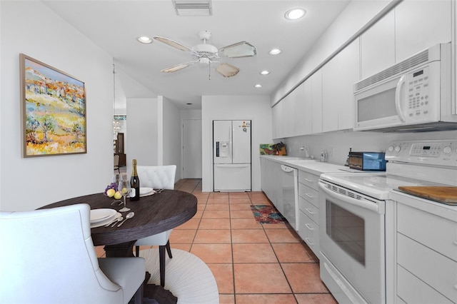 kitchen featuring light tile patterned floors, white appliances, white cabinets, and ceiling fan