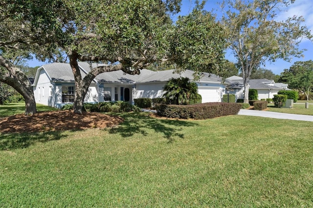 single story home with a front yard and a garage