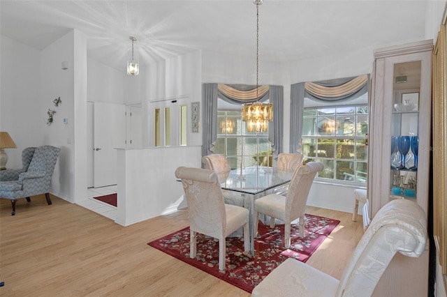 dining area featuring hardwood / wood-style flooring and a notable chandelier