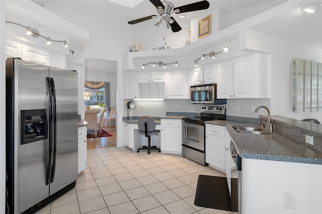 kitchen with light tile patterned floors, white cabinetry, sink, and appliances with stainless steel finishes