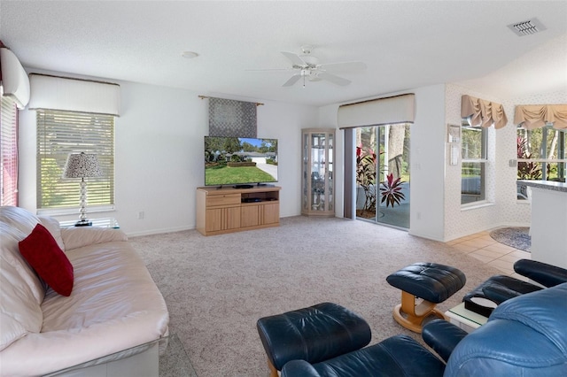 carpeted living room featuring a wealth of natural light, ceiling fan, and a textured ceiling