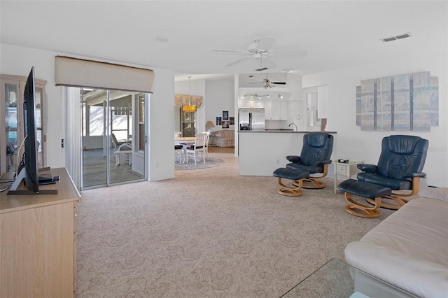 carpeted living room featuring ceiling fan