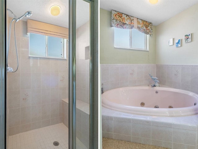 bathroom featuring a textured ceiling and independent shower and bath