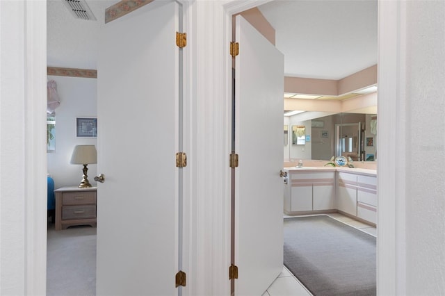 corridor with light colored carpet