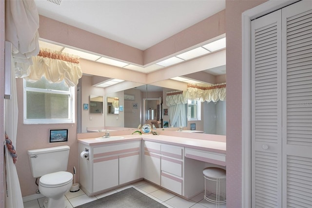 bathroom featuring toilet, vanity, and tile patterned floors