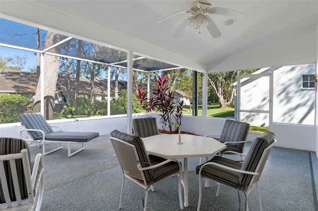 sunroom / solarium featuring ceiling fan, plenty of natural light, and lofted ceiling