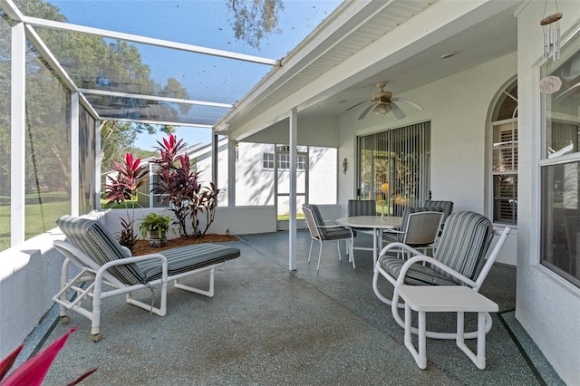 sunroom / solarium featuring ceiling fan and plenty of natural light