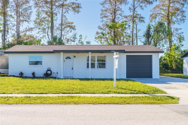 ranch-style house with a garage and a front lawn