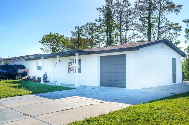 view of property exterior featuring a yard and a garage