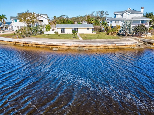 exterior space featuring a yard and a water view