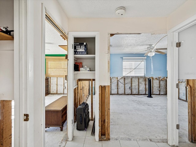 hall with a textured ceiling