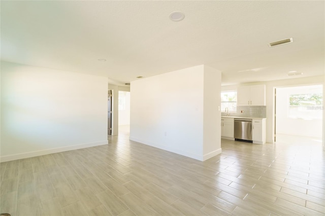 unfurnished room featuring light hardwood / wood-style flooring and sink