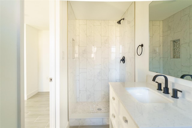 bathroom featuring vanity and tiled shower