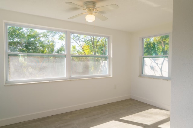 empty room with light hardwood / wood-style flooring and ceiling fan