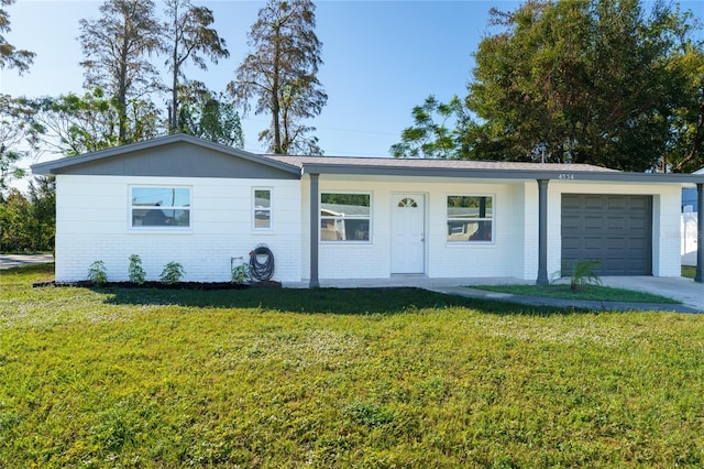 ranch-style home featuring a garage and a front lawn