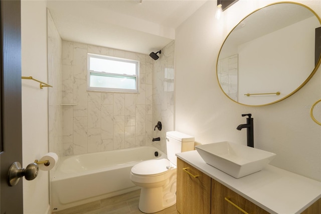 full bathroom featuring vanity, wood-type flooring, tiled shower / bath combo, and toilet