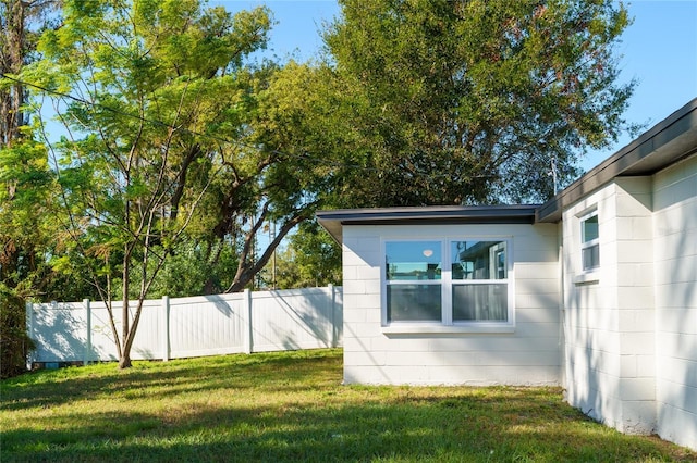 view of property exterior with a yard