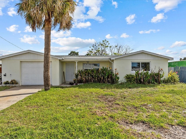 ranch-style house with a garage and a front lawn